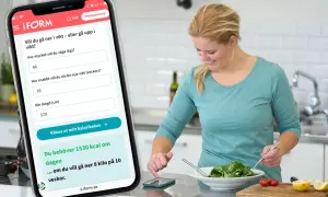 Kvinna använder app för att räkna ut sitt kaloribehov. Appen visar 1530 kcal/dag för viktnedgång, men inte hur mycket kolhydrater per dag.