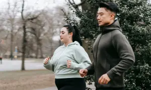 Ett par joggar utomhus, en del av deras resa för att gå ner i vikt utan att banta.