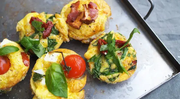 Små omelettmuffins med tomat, spenat och bacon. Perfekt nyttig sommarmat för en lätt lunch eller frukost.